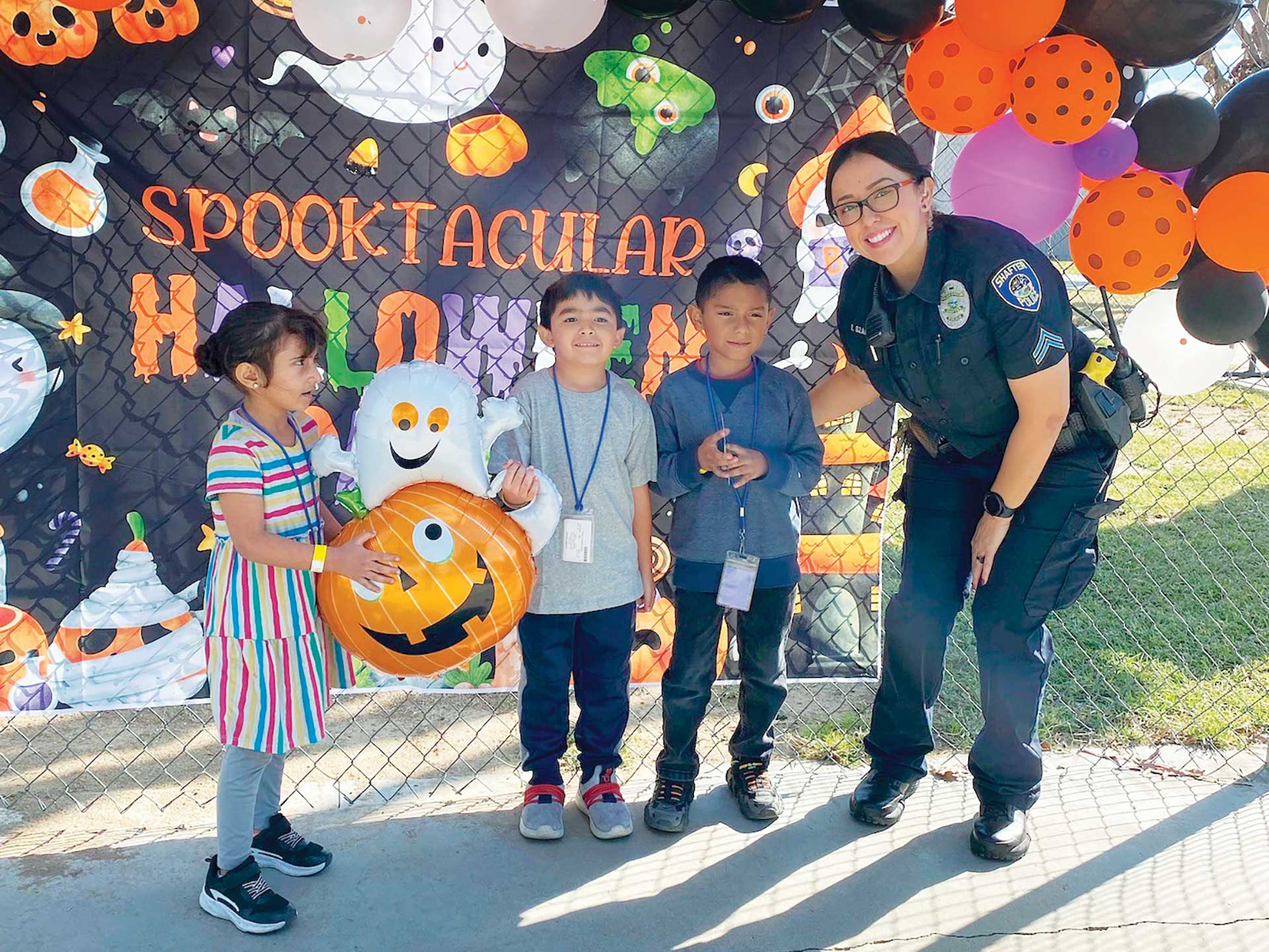 feature-a-salute-to-school-resource-officers-3-Shafter-Senior-Police-Officer-Rachel-Ozaeta-celebrating-Halloween-with-a-group-of-students